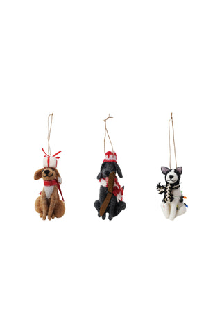 Three dog-shaped Christmas ornaments on a white background