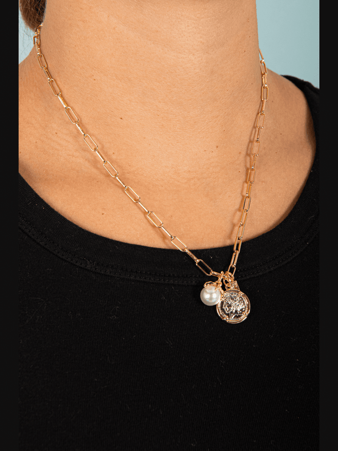 Embrace elegance and charm with our 3 Charm Chain Link Necklace. This beautiful piece features three delicate charms on a stylish chain, adding a touch of sophistication to any outfit. Elevate your style and make a statement with this must-have accessory.
