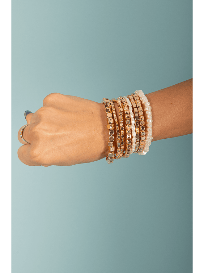 Indulge in luxury with our 7 Row Gold &amp; Pearl Bracelets. Each bracelet features delicate rows of lustrous pearls intertwined with elegant gold, creating a timeless and sophisticated look. Elevate any outfit and make a statement with this stunning piece of jewelry.