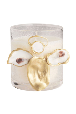 Candle with gold and white floral decorations on a white background