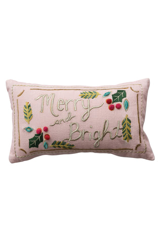 Decorative pillow with 'Merry and Bright' text and holly leaves on a white background
