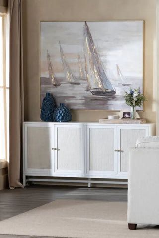 Living room with a white cabinet, decorative vases, and a large painting of sailboats.