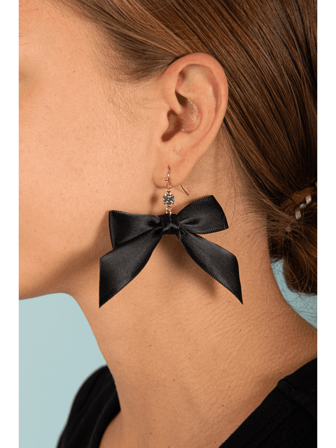 Enhance your style with our Silky Dangle Bow Earrings! These elegant earrings feature a delicate dangle design with a beautifully silky texture and charming bow accent. Perfect for adding a touch of sophistication to any outfit. Elevate your look and feel confident and chic with our Silky Dangle Bow Earrings.