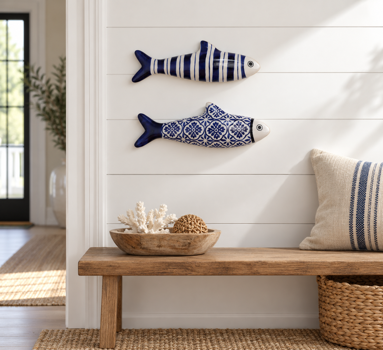 Navy striped and blue tile stoneware fish displayed on a white entryway wall
