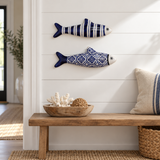 Navy striped and blue tile stoneware fish displayed on a white entryway wall