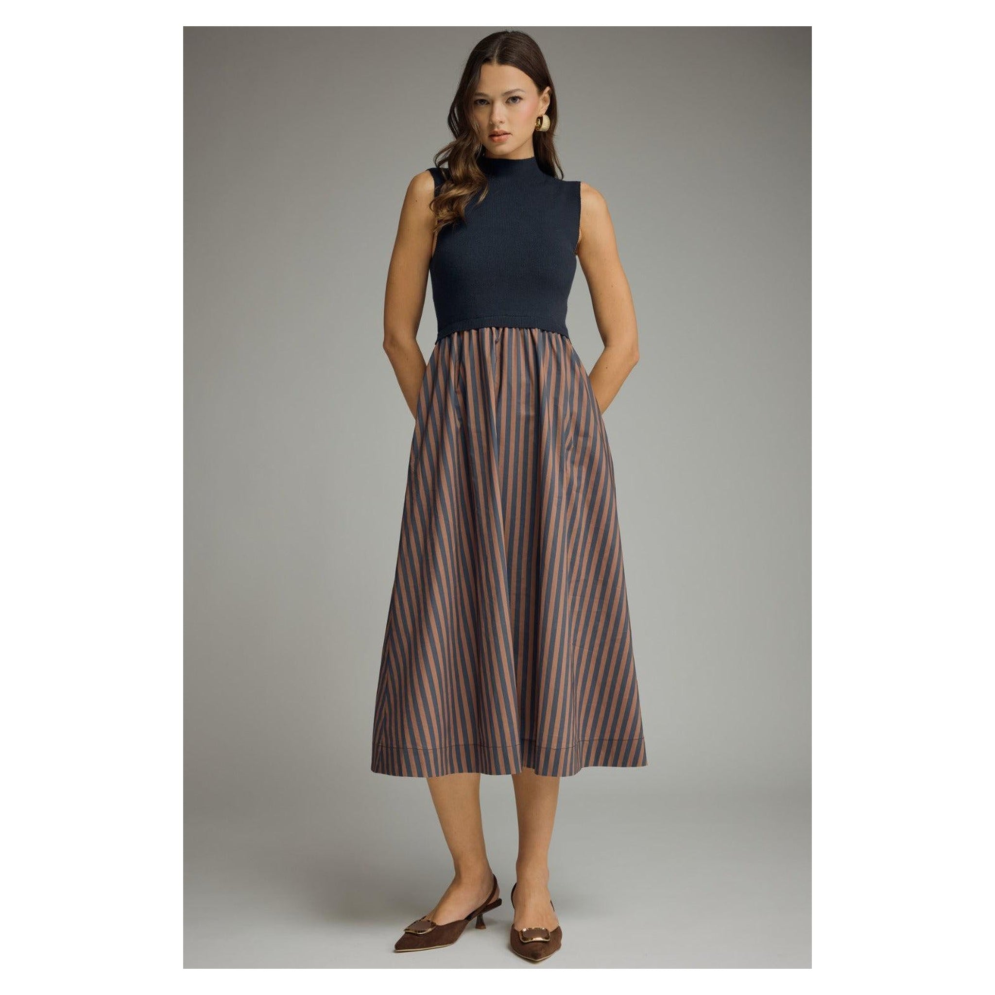 Navy mock-neck midi dress with striped skirt, front model view