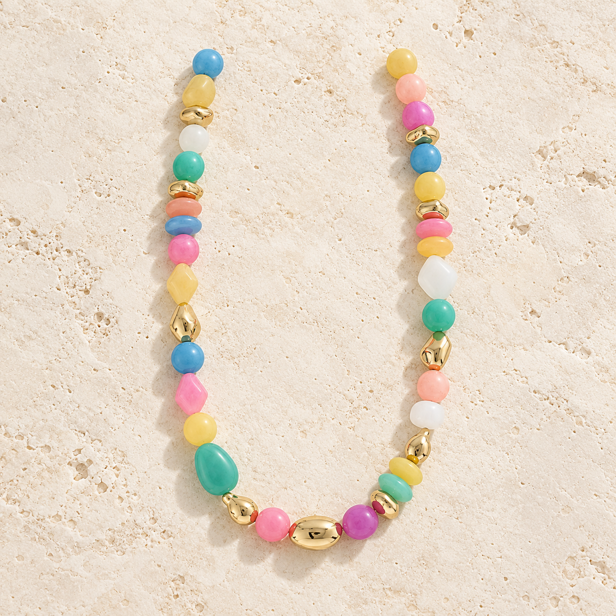 Multicolor beaded statement necklace with pink, turquoise, blue, yellow and gold-tone beads.