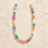 Multicolor beaded statement necklace with pink, turquoise, blue, yellow and gold-tone beads.