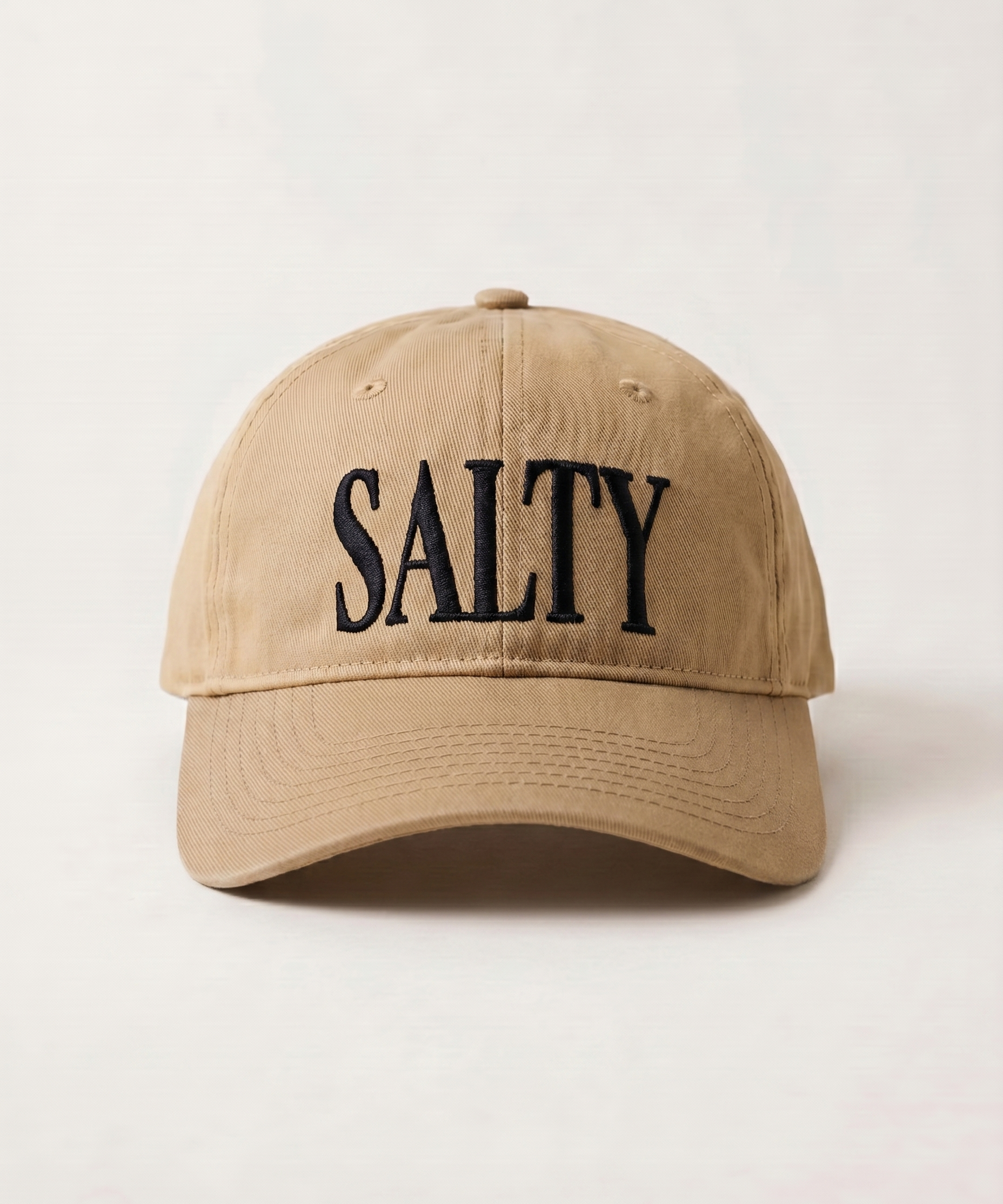 Beige cap with 'SALTY' text on a light beige background