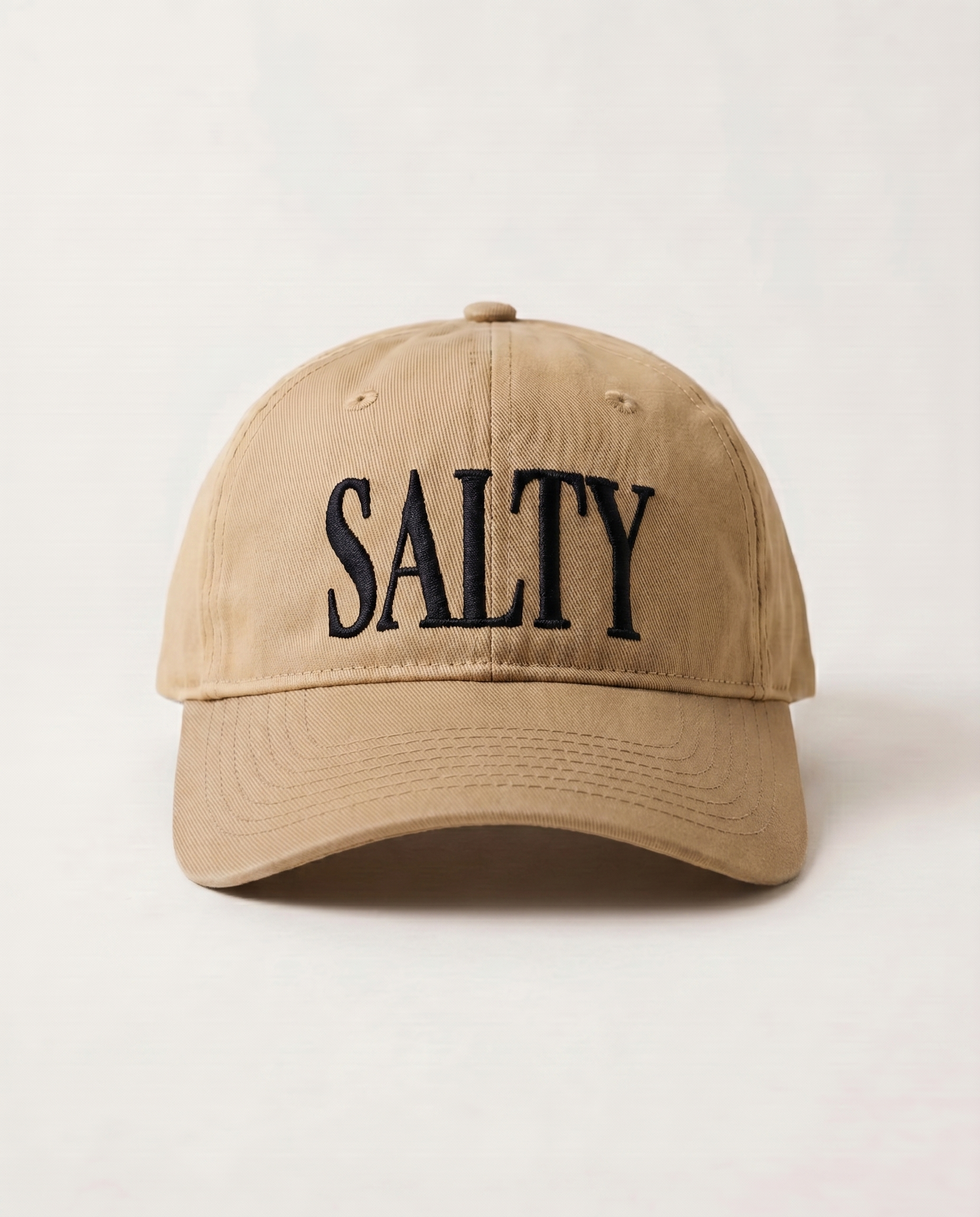 Beige cap with 'SALTY' text on a light beige background