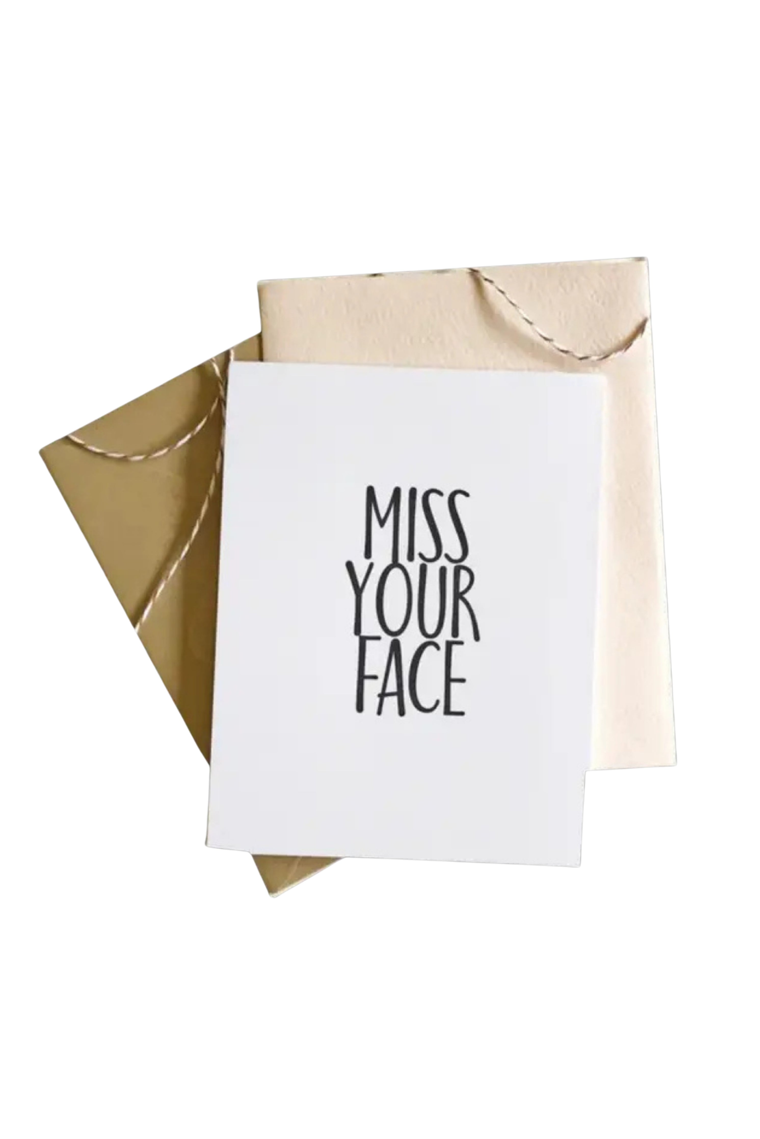 Greeting card with 'Miss Your Face' text and beige envelope on white background