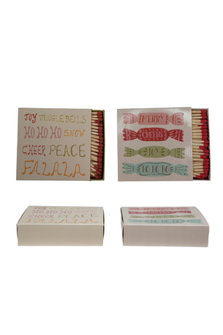 Four matchboxes with festive designs on a white background
