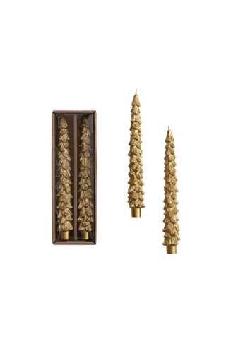 Decorative candles with intricate designs on a white background