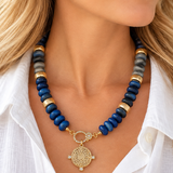 Model wearing blue and gray medallion beaded necklace
