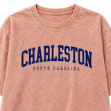 Close-up of navy Charleston South Carolina lettering and washed peach crewneck tee
