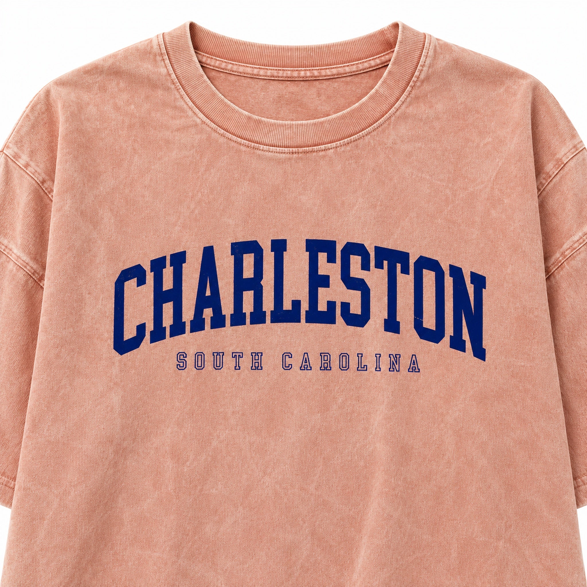 Close-up of navy Charleston South Carolina lettering and washed peach crewneck tee