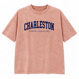 Dusty peach washed Charleston South Carolina graphic tee with navy lettering, front view