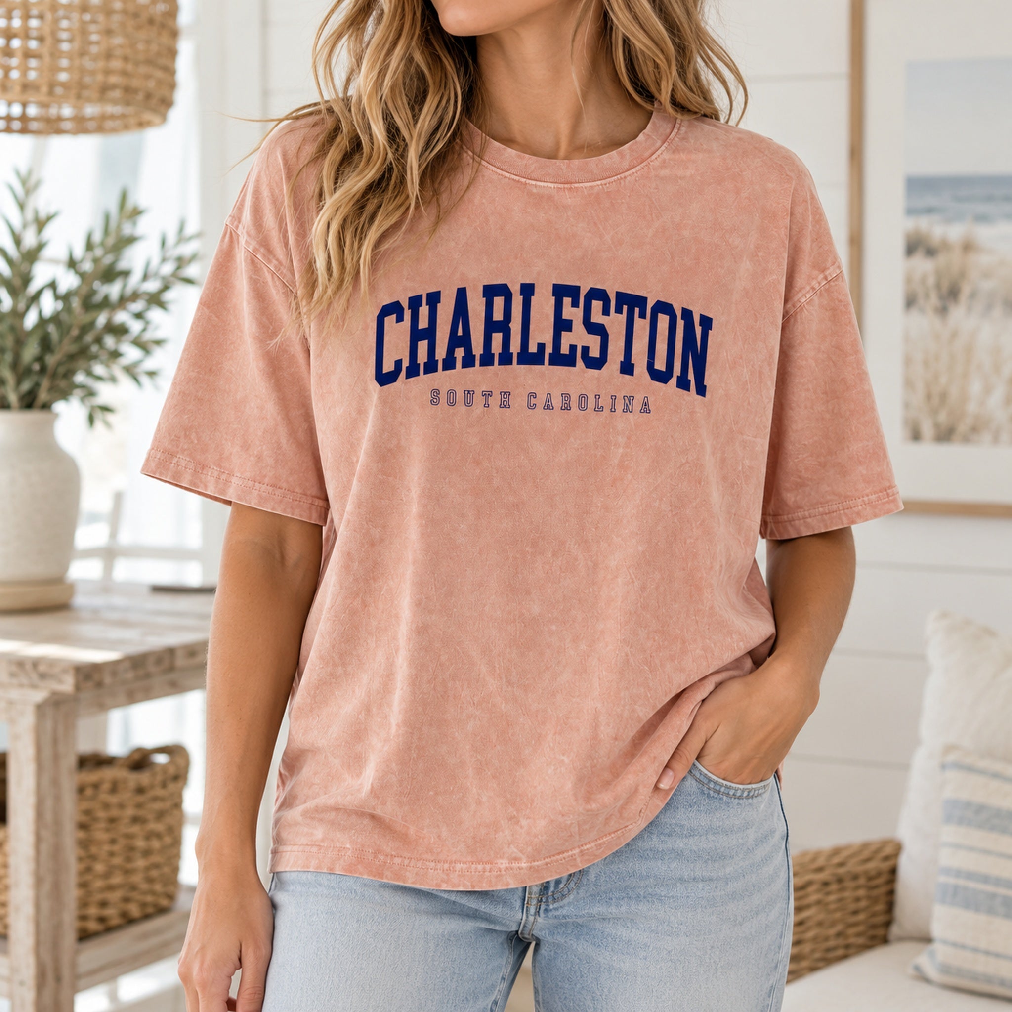 Model wearing dusty peach Charleston graphic tee with light denim