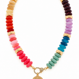 Multicolor coastal medallion beaded necklace featuring pink, coral, yellow, purple, blue, and turquoise acrylic rondelle beads, gold-tone accents, and an ornate medallion pendant.