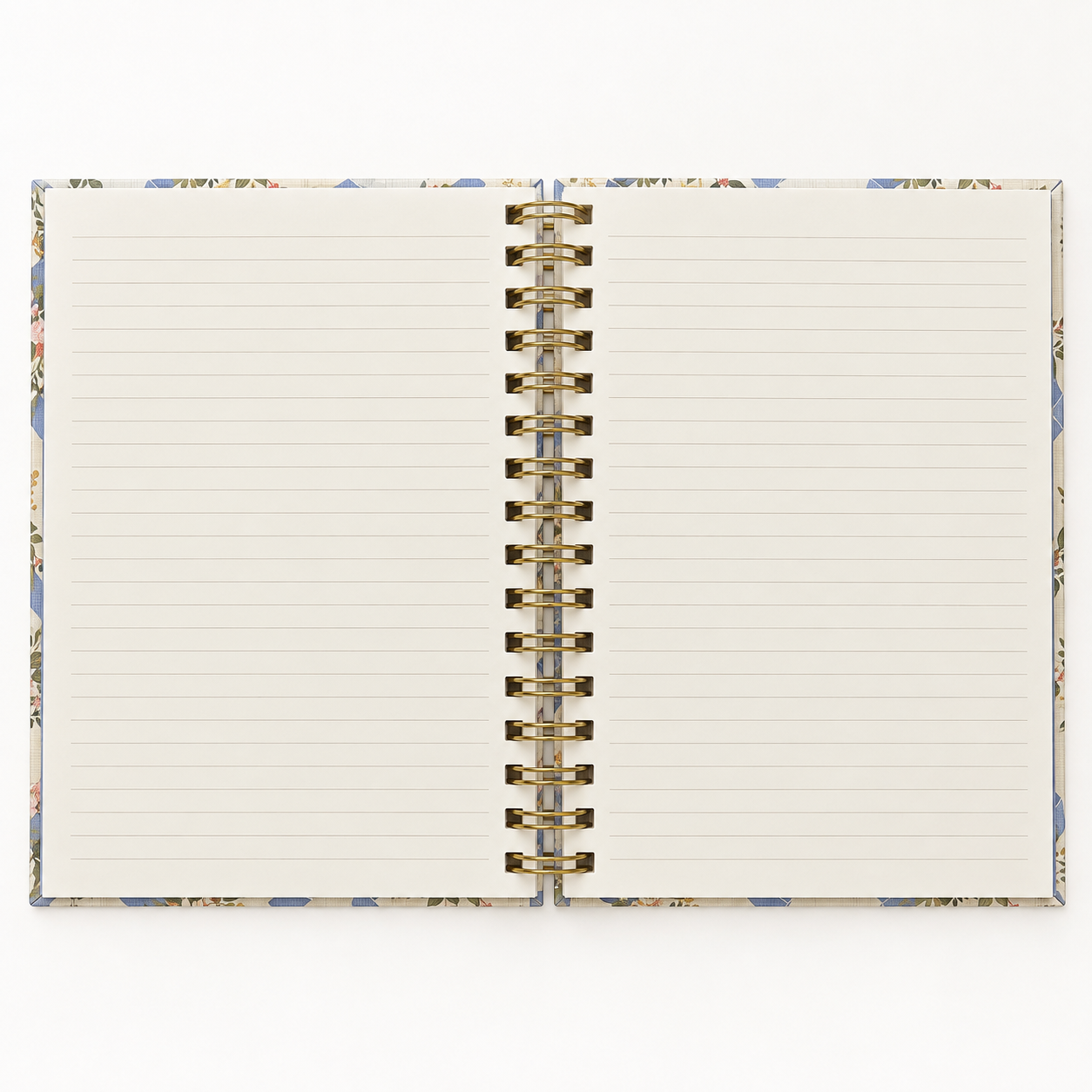Open floral spiral notebook showing lined cream pages and gold-tone wire binding