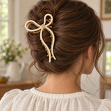 Cream acrylic inlay gold-tone bow claw hair clip worn in a brunette updo