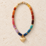 Chunky rainbow beaded necklace with gold-tone spacers and a polished heart pendant