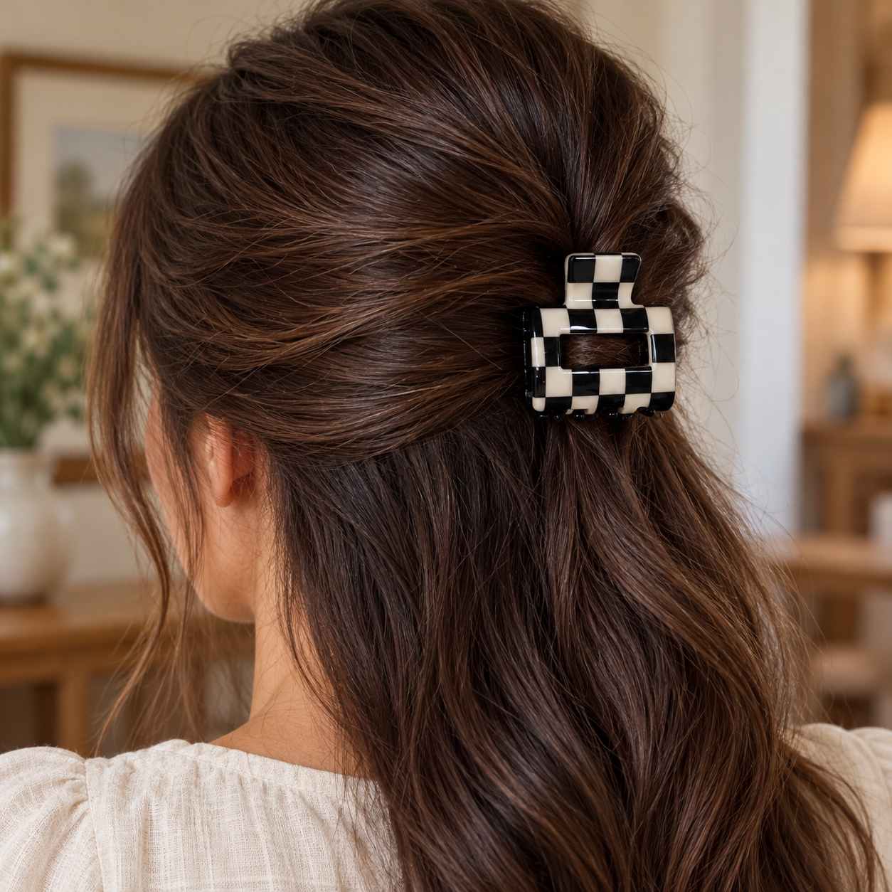 Checkered rectangle claw hair clip worn in a brunette half-up hairstyle