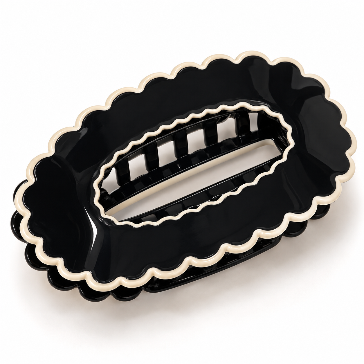 Black scalloped oval claw hair clip on a white background