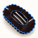 Blue Trim scalloped oval claw hair clip on a white background