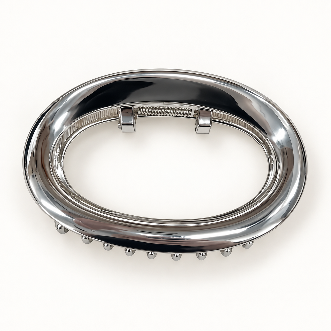 Silver oval claw hair clip on a white background